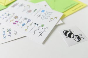 Close up of greeting cards, origami envelopes and sealing stickers